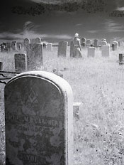 Picture of a gravestone with flowers on top.